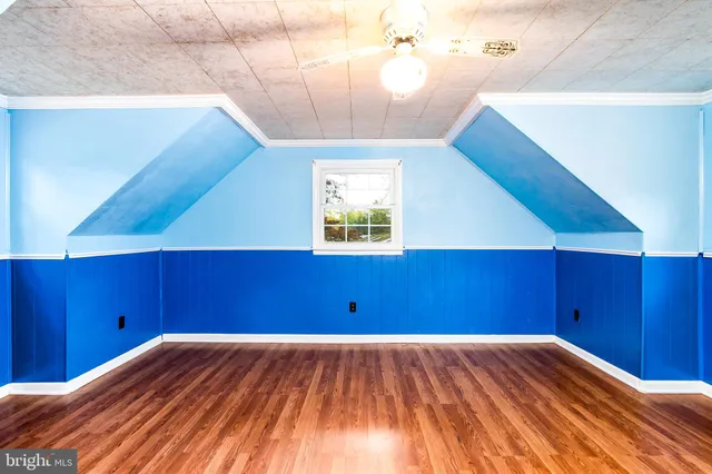 a view of a room with wooden floor and staircase