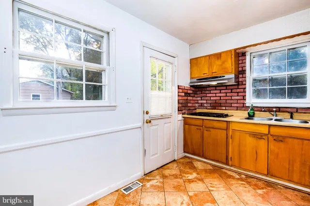 a kitchen with stainless steel appliances granite countertop a sink and cabinets