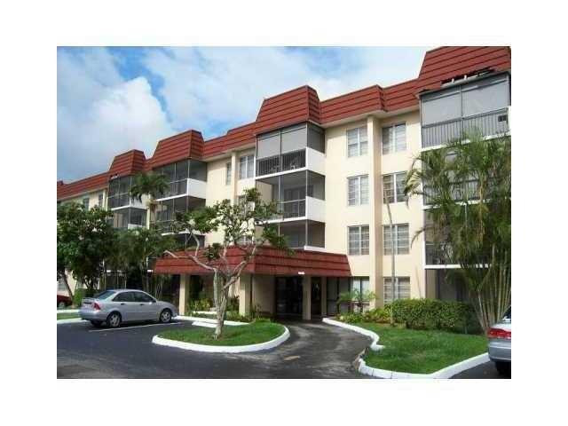 4164 Inverrary Drive, Unit 806 Lauderhill, FL 33319 - Photo 2 of 23 a front view of a house with a garden and plants