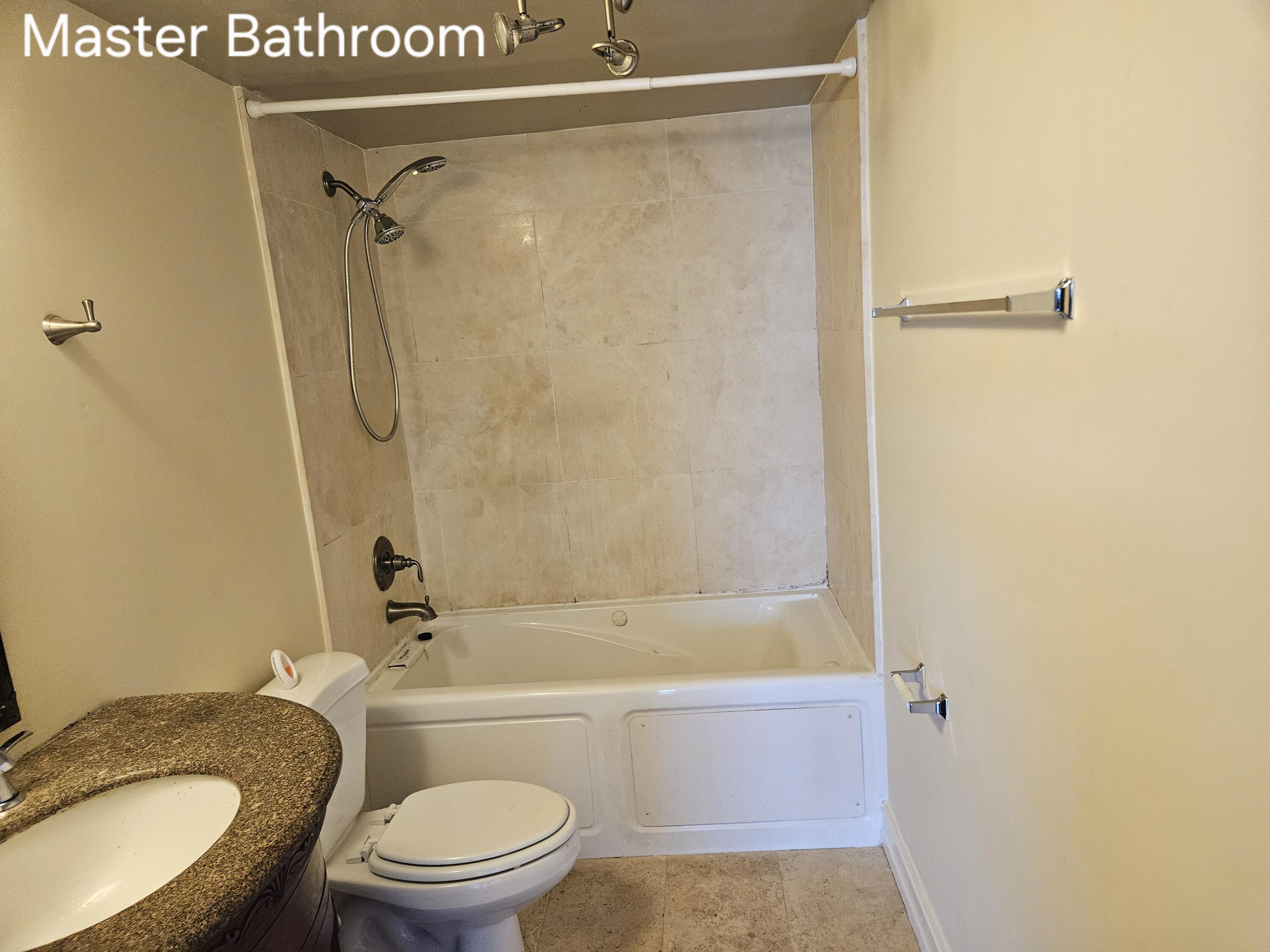 4164 Inverrary Drive, Unit 806 Lauderhill, FL 33319 - Photo 22 of 23 a bathroom with a granite countertop toilet sink and shower