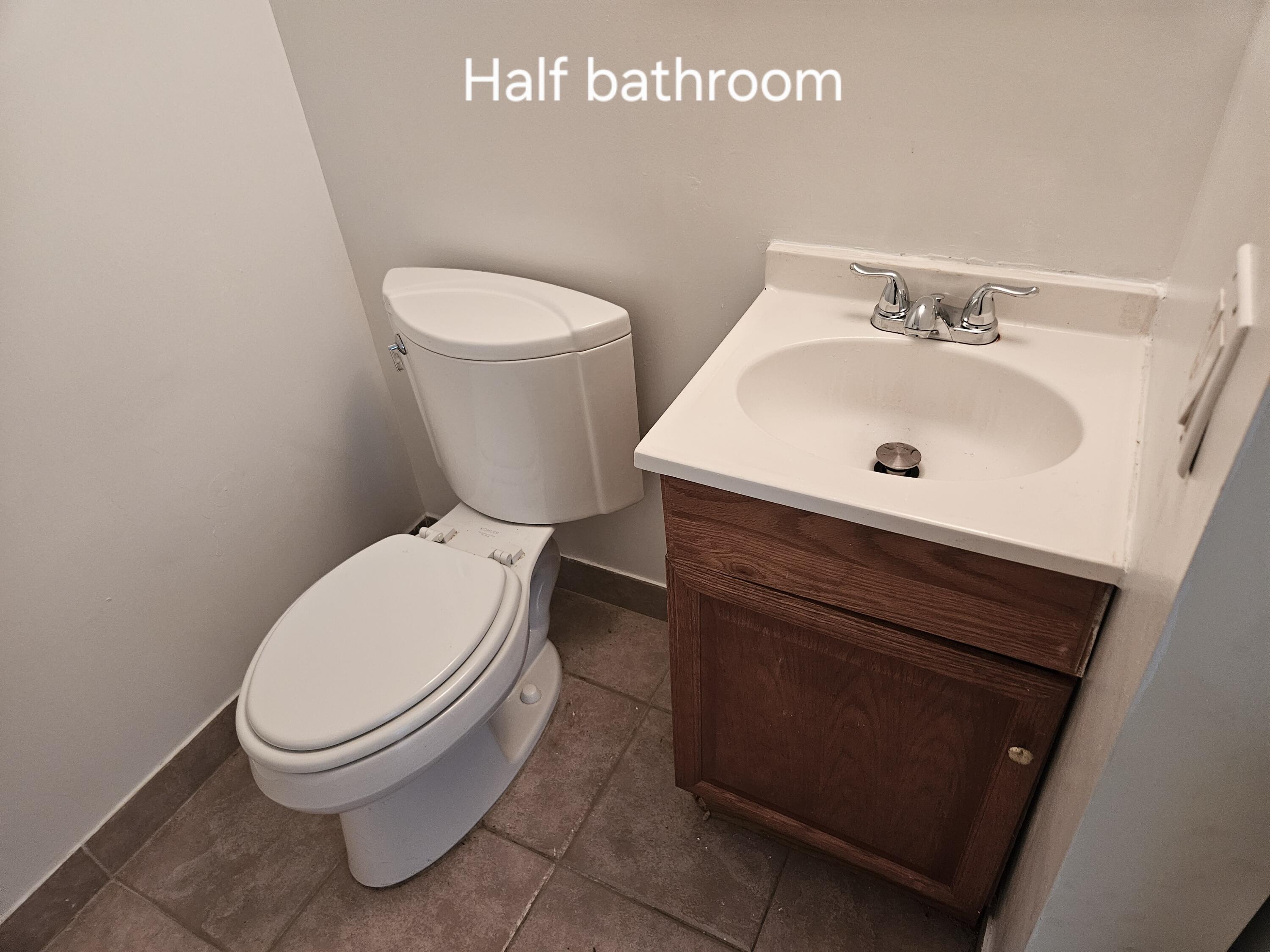 4164 Inverrary Drive, Unit 806 Lauderhill, FL 33319 - Photo 23 of 23 a white toilet sitting next to a bathroom sink