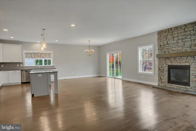 a view of kitchen with kitchen island and stainless steel appliances