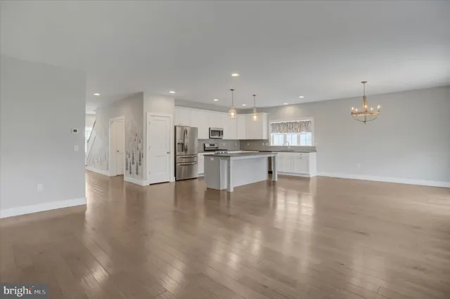 a living room with a fireplace and a floor to ceiling window