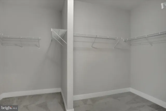 a view of an empty room and closet area