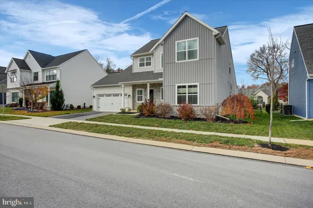 a front view of house with yard and green space
