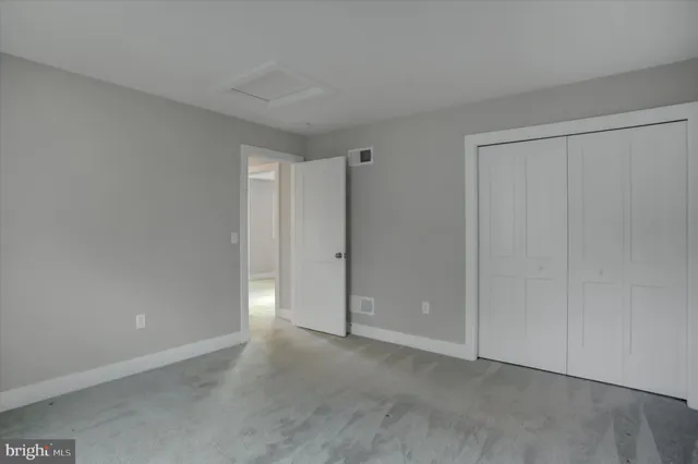 a front view of a house with a garden and trees