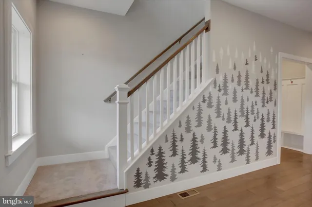 view of a hallway with wooden floor and staircase
