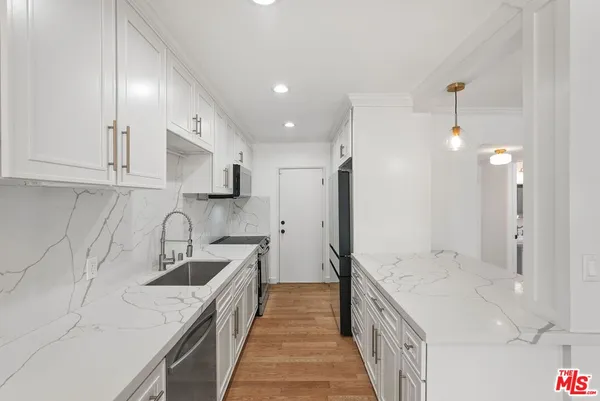 a kitchen with a sink stove and refrigerator