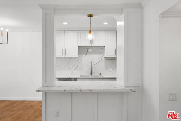 a kitchen with a sink and cabinets