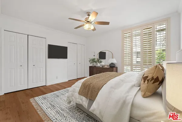 a bedroom with a large bed and a chandelier