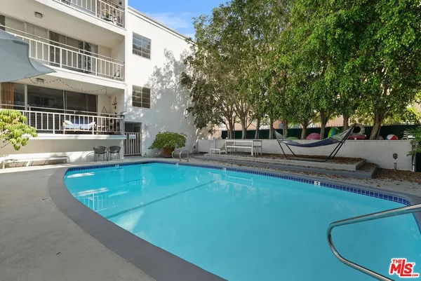 a view of a swimming pool with a lounge chair