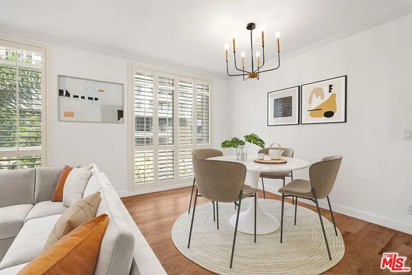 a view of a livingroom with furniture window and wooden floor