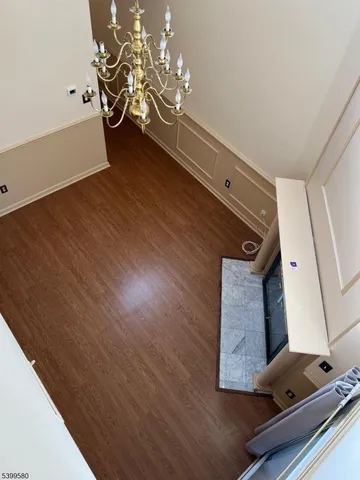 a view of a room with wooden floor and potted plant