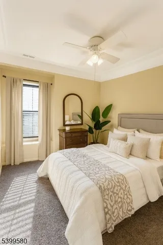 a bedroom with a bed and dresser