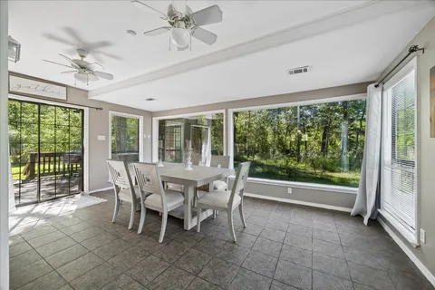 a dining room with furniture a chandelier and fireplace
