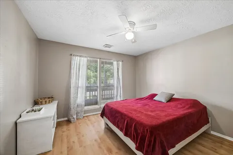 a spacious bedroom with a bed and a window