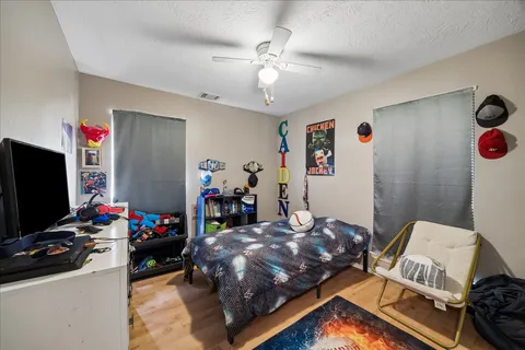 a bed room with a bed and a television