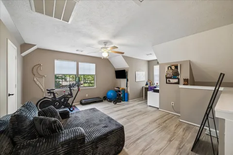 a bed room with furniture and a flat screen tv