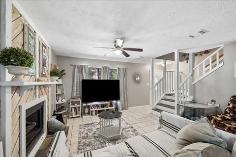 a living room with furniture a fireplace and a flat screen tv