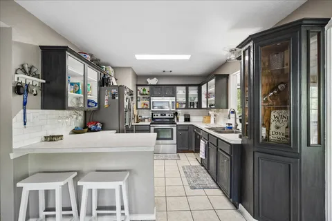 a kitchen with stainless steel appliances granite countertop a refrigerator and a sink