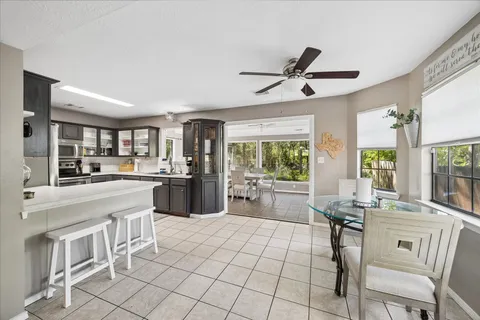 a kitchen with a sink cabinets and dining table chair