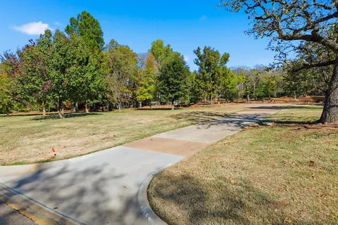 a view of a swimming pool with a yard