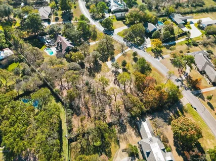 an aerial view of residential houses with yard