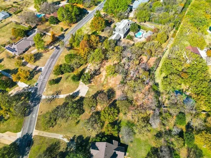 an aerial view of residential houses with city view