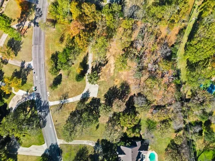 an aerial view of residential houses with city view