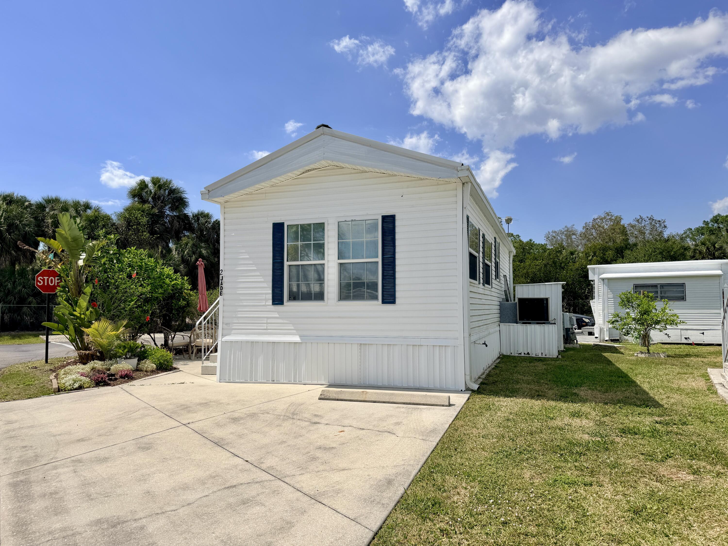2 Jade Drive Naples, FL 34114 - Photo 31 of 44 a front view of a house with a yard and potted plants