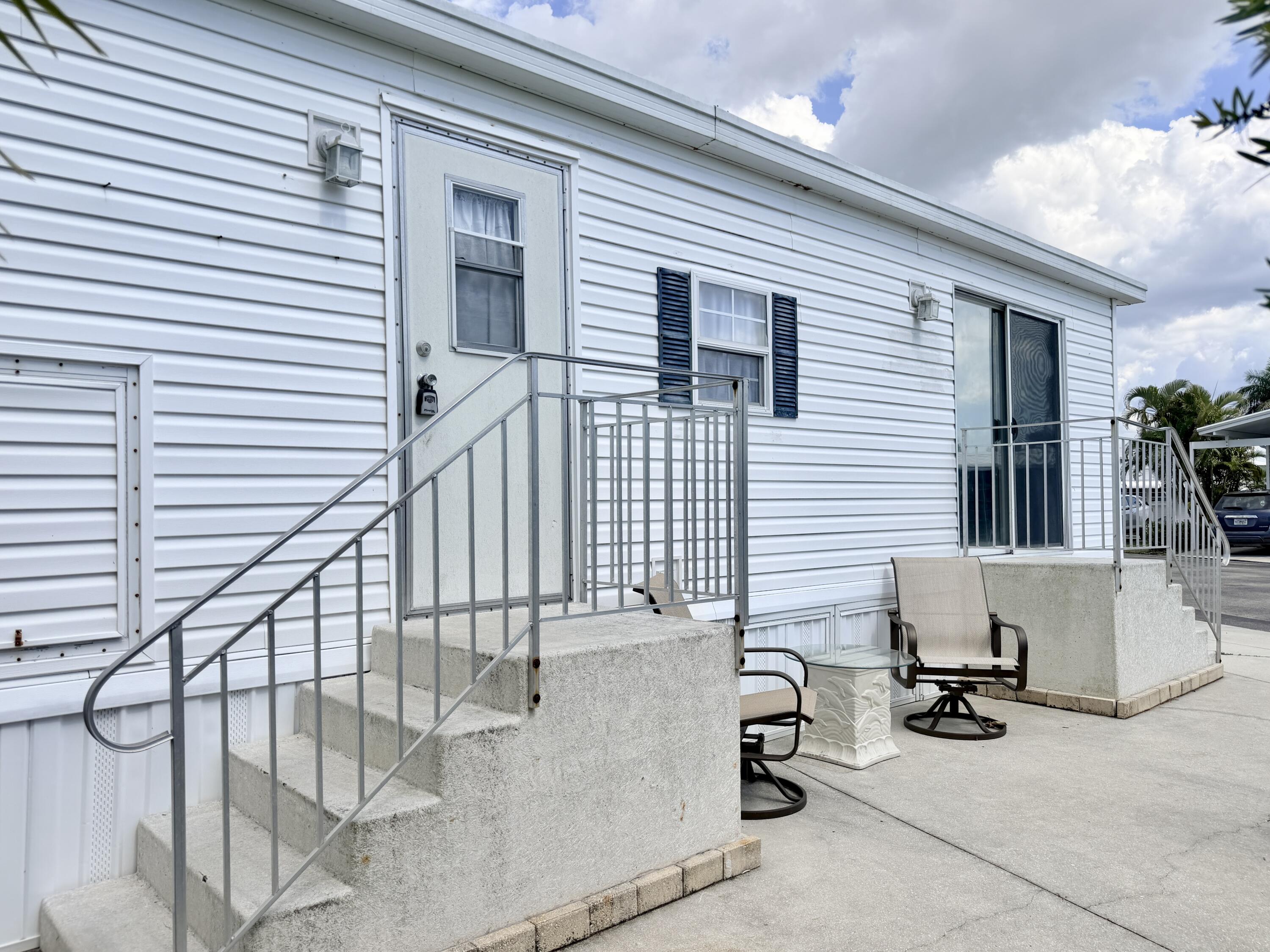 2 Jade Drive Naples, FL 34114 - Photo 32 of 44 a view of balcony with couch and chairs