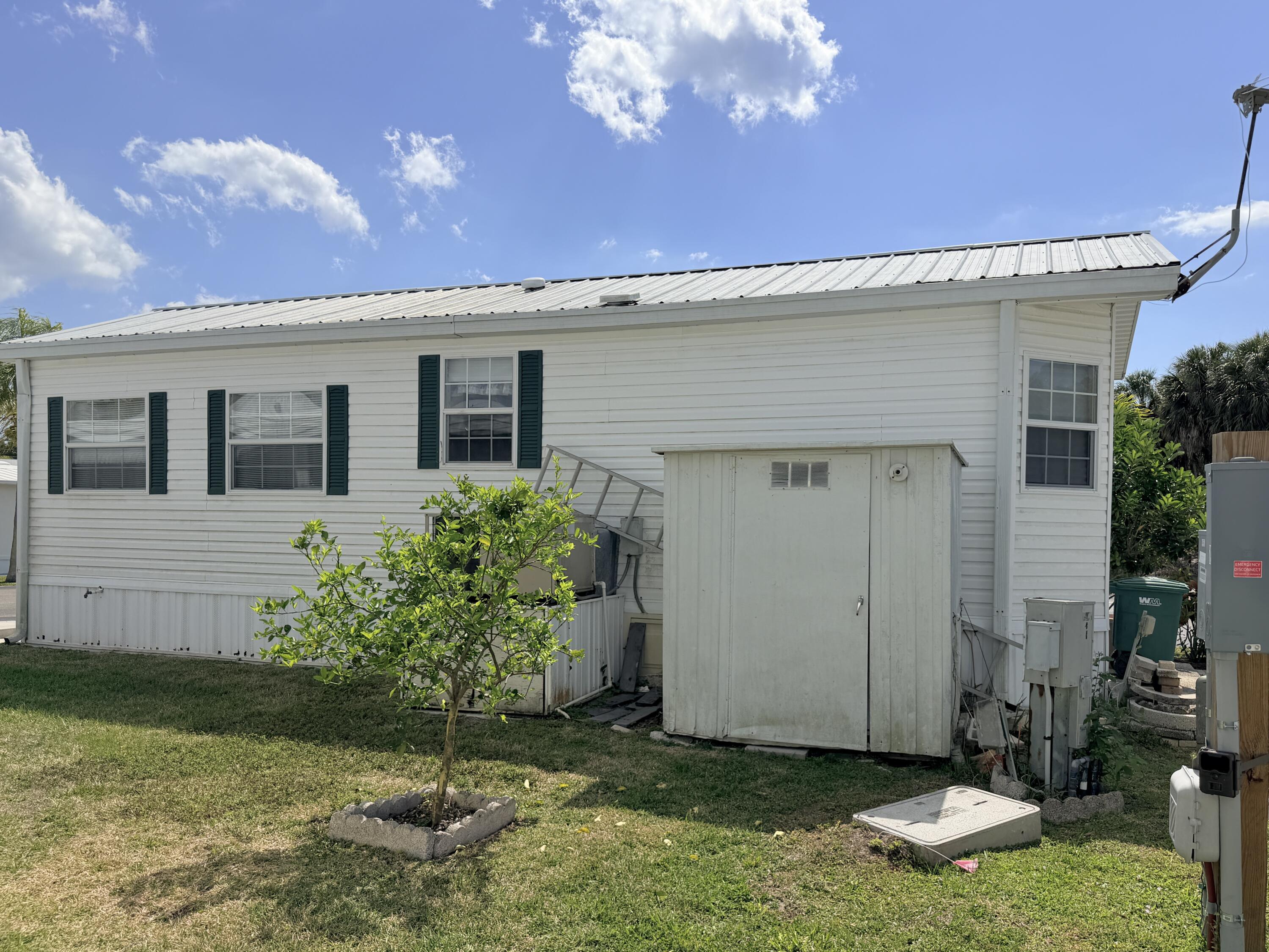 2 Jade Drive Naples, FL 34114 - Photo 35 of 44 a front view of a house with garden