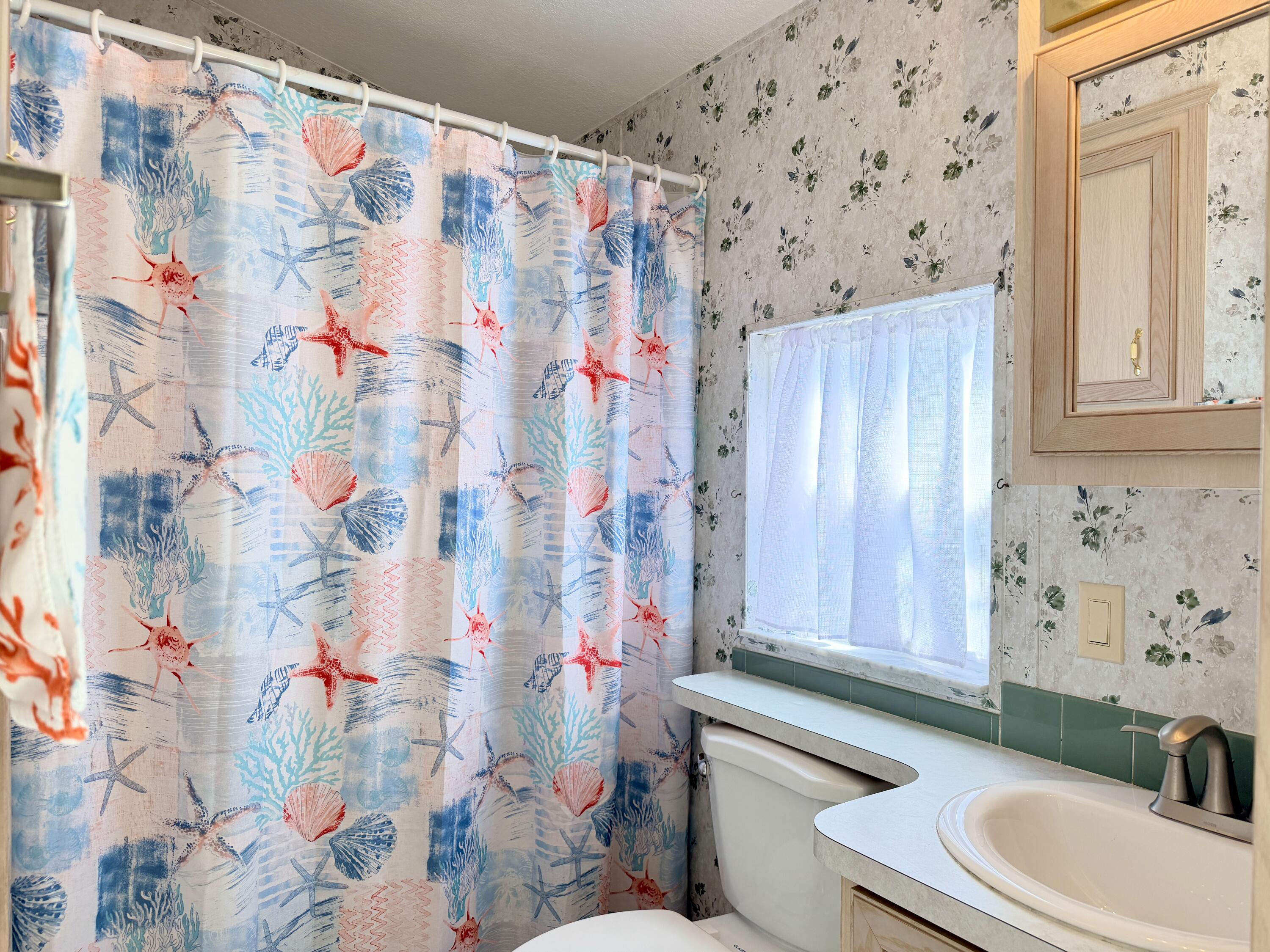2 Jade Drive Naples, FL 34114 - Photo 5 of 44 a bathroom with a sink toilet and shower curtain