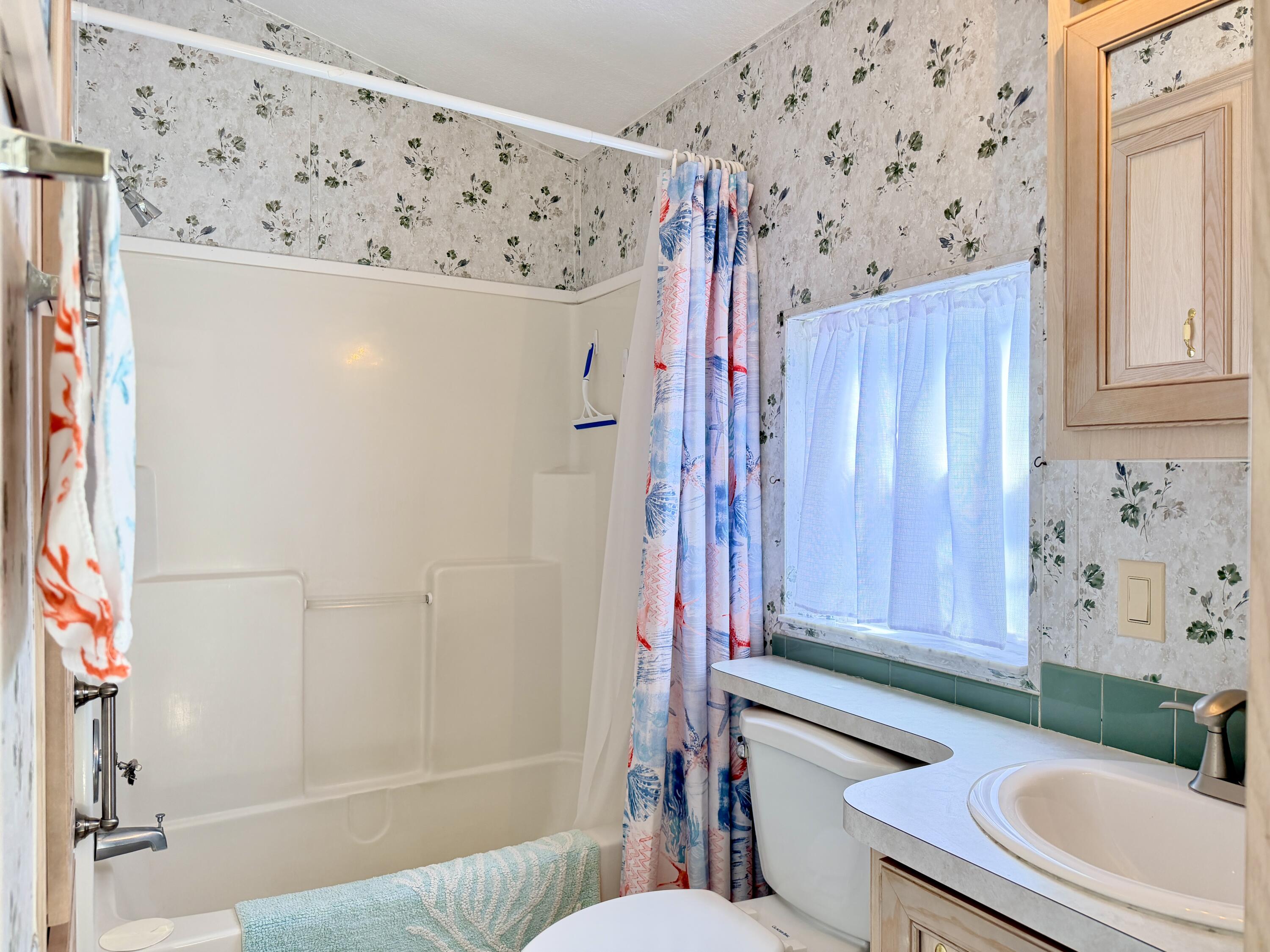 2 Jade Drive Naples, FL 34114 - Photo 6 of 44 a bathroom with a shower curtain and a sink