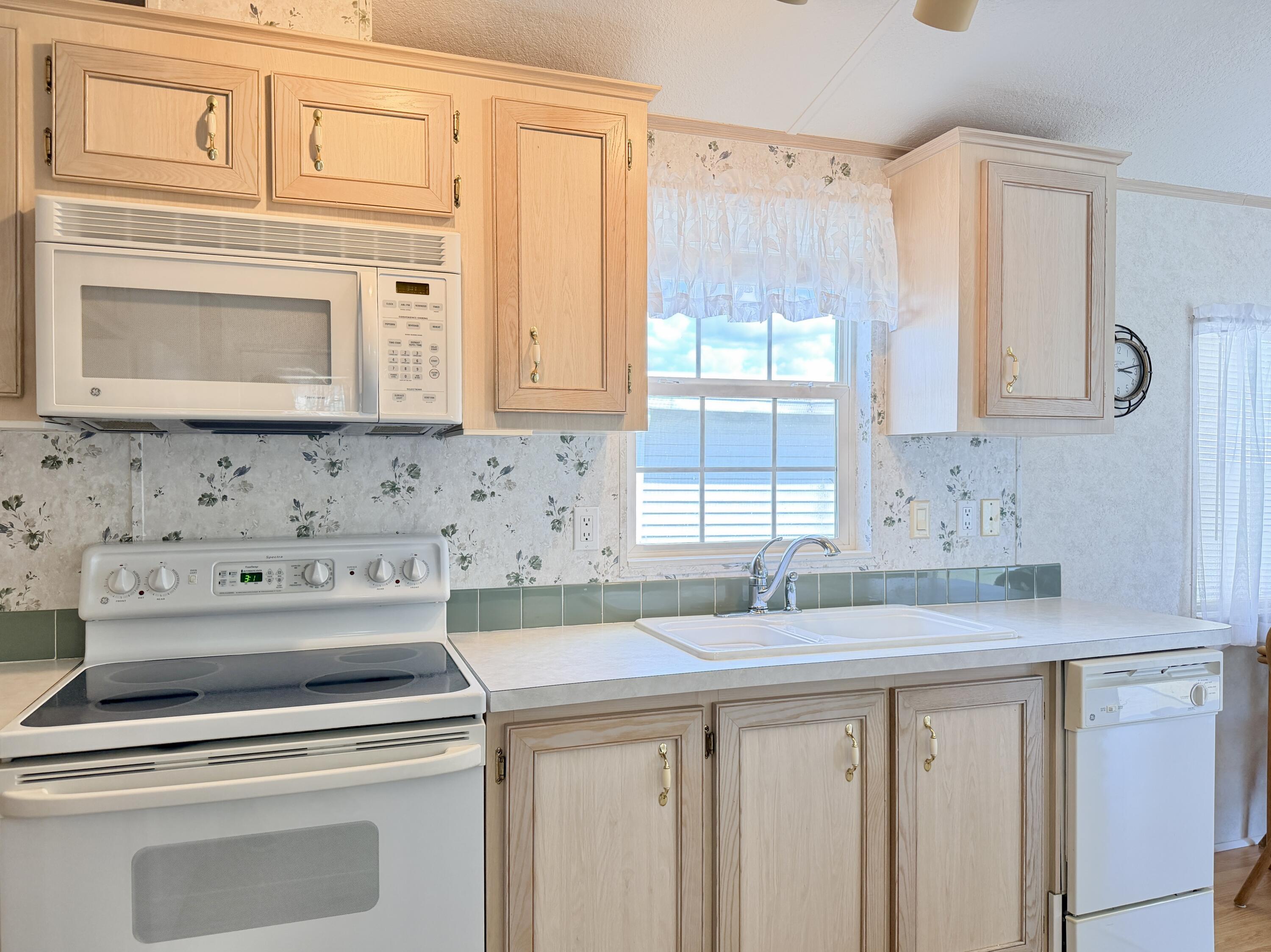 2 Jade Drive Naples, FL 34114 - Photo 10 of 44 a kitchen with a sink cabinets and a window