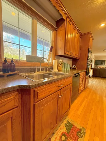a kitchen with stainless steel appliances a sink and cabinets