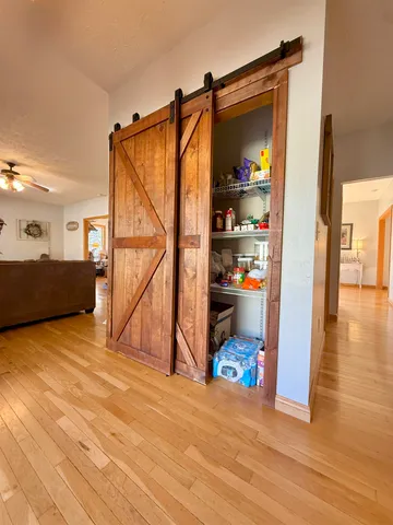 a view of a living room with a bed and cabinets