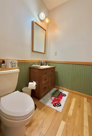 a bathroom with a toilet sink and mirror