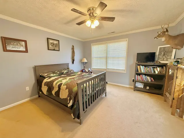 a room with stainless steel appliances kitchen island granite countertop a sink and a cabinets