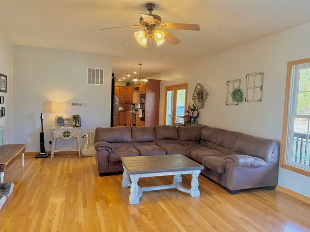 a living room with furniture and a chandelier