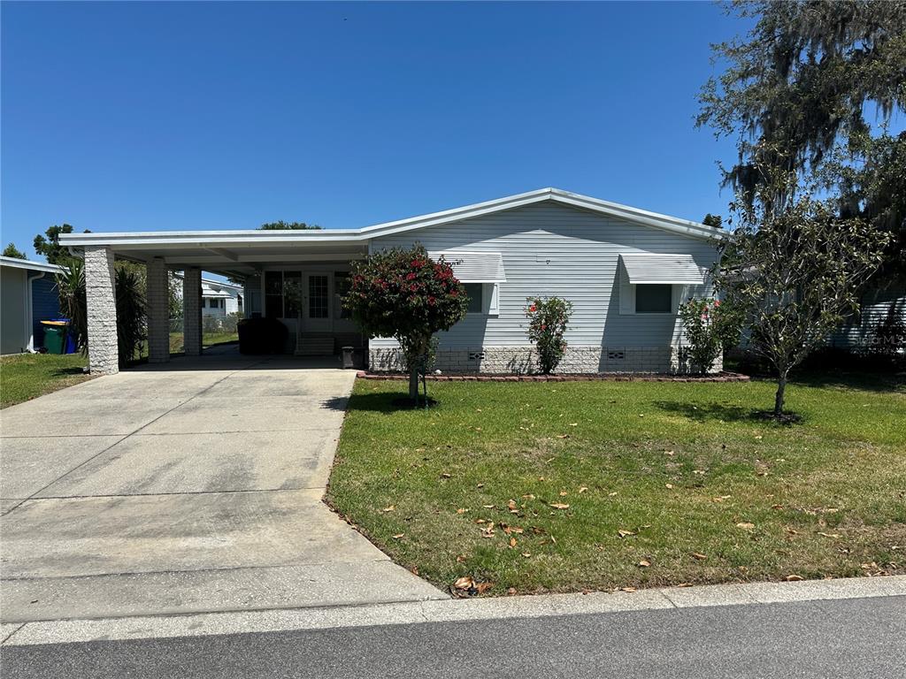 3302 Wekiva Road Tavares, FL 32778 - Photo 1 of 31 a front view of a house with garden