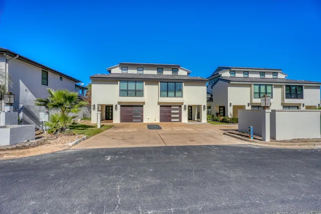 a front view of a house with a yard and a garage