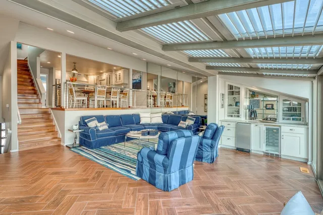 a living room with furniture a dining table and kitchen view