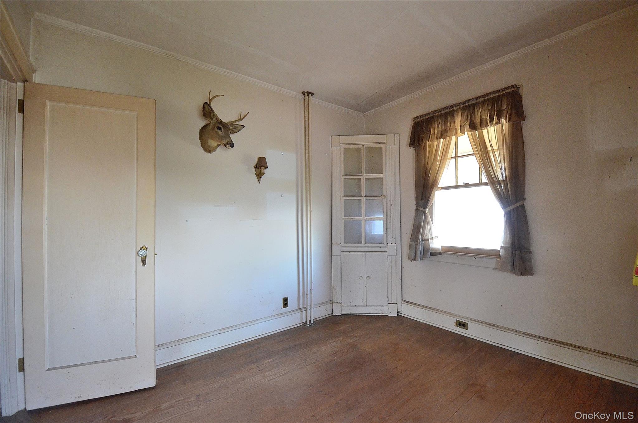 2586 Riverside Drive Wantagh, NY 11793 - Photo 12 of 28 Bedroom featuring hardwood flooring, light-toned walls, white trim