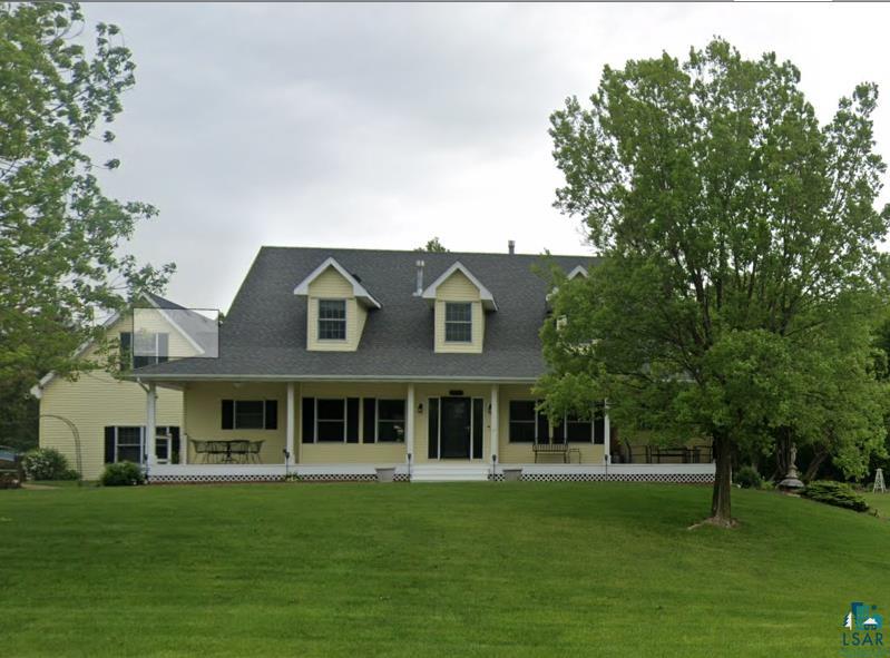 10595 Prairie Lane Hanover, MN 55341 - Photo 1 of 20 Yellow-sided residence with a dark shingled roof and multiple dormer windows