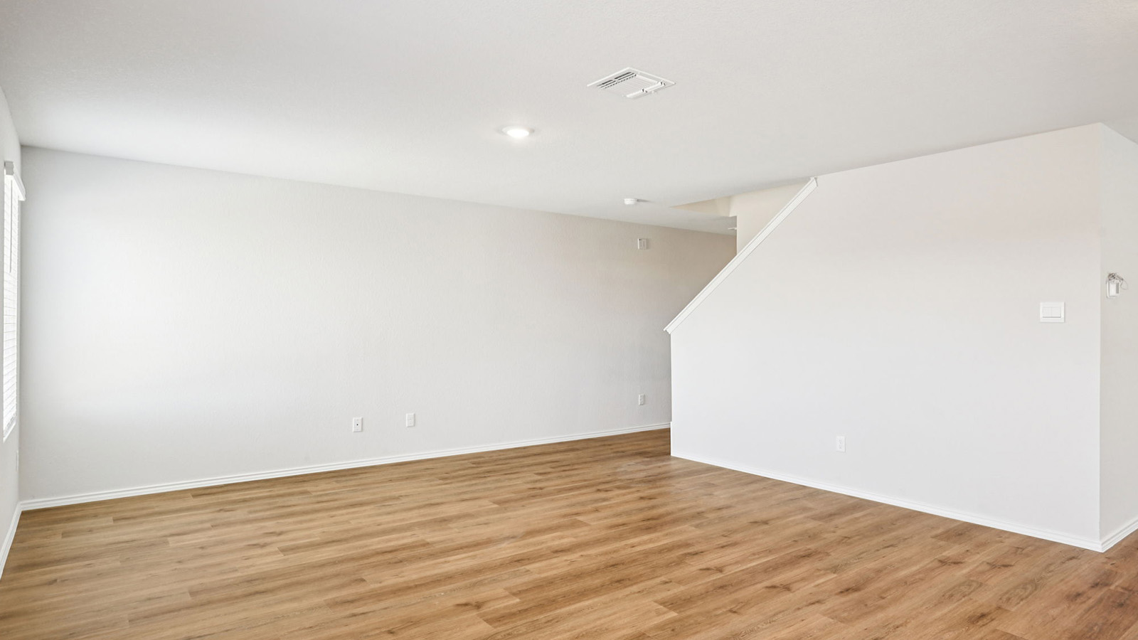 133 Wyatt Way Jarrell, TX 76537 - Photo 11 of 32 Open-concept living area featuring wood-finish flooring, recessed lighting, white walls, and white trim