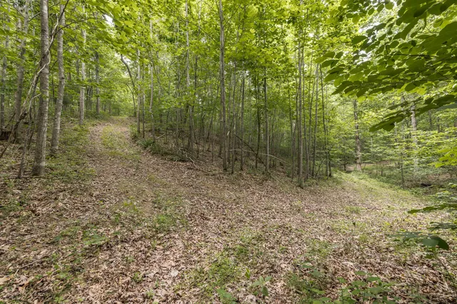 a view of balcony with a large window and wooden floor