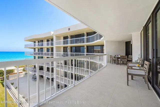 a spacious bedroom with a bed a chandelier and closet