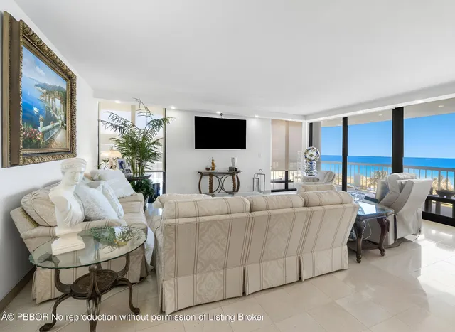 a living room with couches a dining table and chairs with outer view