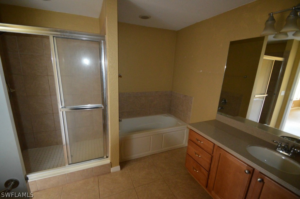 11706 Tempest Harbor Loop Venice, FL 34292 - Photo 11 of 20 a bathroom with a bathtub and a shower